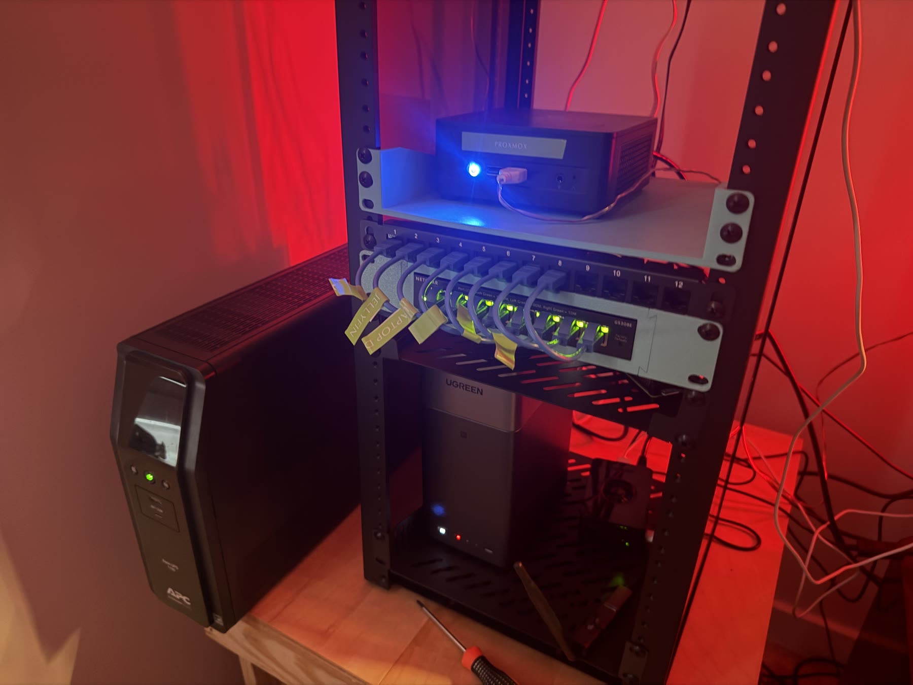 My homelab rack with networking equipment, development systems, and UPS